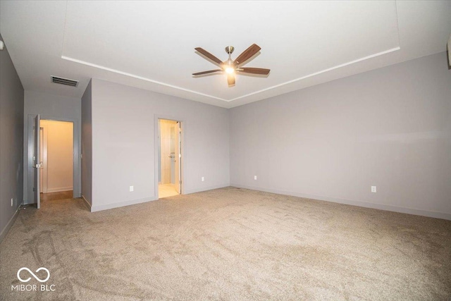 unfurnished bedroom with ensuite bath, ceiling fan, and light carpet