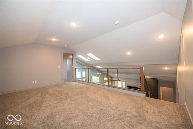 bonus room with carpet floors and lofted ceiling with skylight