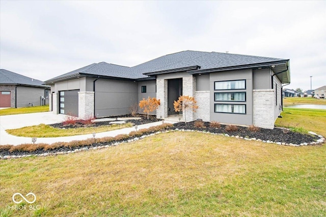 prairie-style home featuring a garage and a front yard