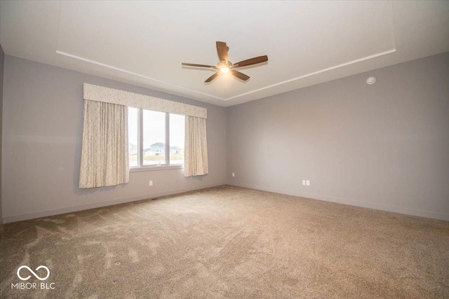 spare room featuring ceiling fan and carpet