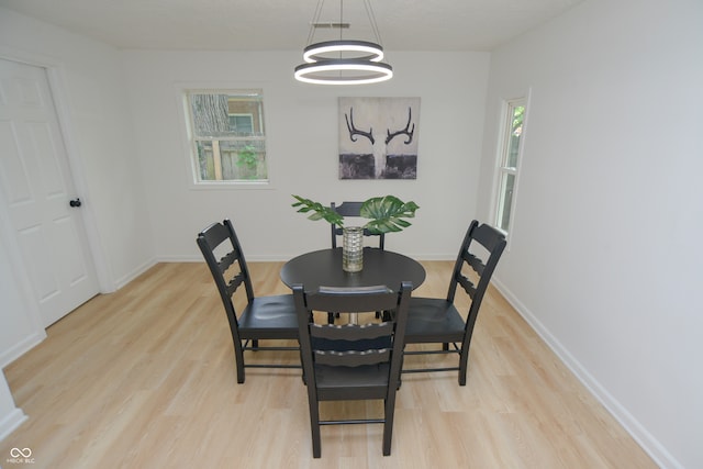 dining room featuring a chandelier and light hardwood / wood-style flooring