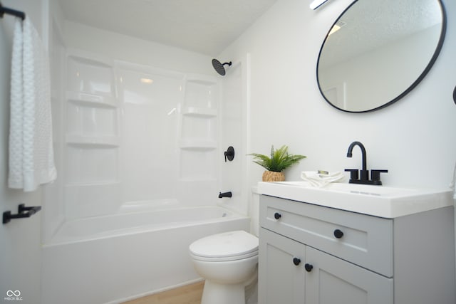 full bathroom featuring shower / bathtub combination, toilet, hardwood / wood-style floors, large vanity, and a textured ceiling