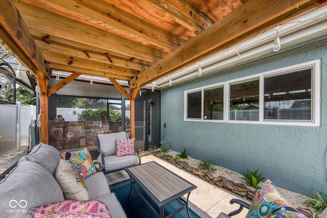 view of patio / terrace featuring an outdoor living space and fence