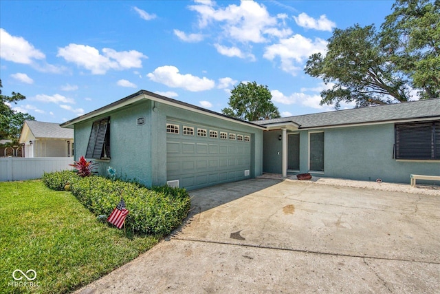 single story home featuring fence, driveway, an attached garage, stucco siding, and a front lawn