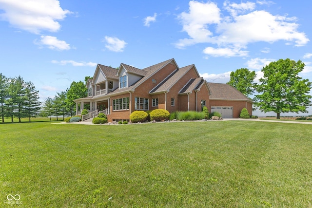 new england style home with a front yard and a garage