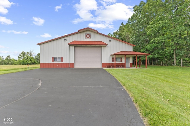 view of front of house with covered porch, a front lawn, and a garage