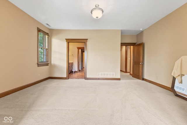 empty room with light colored carpet