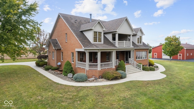 view of front of property with a front yard, a porch, and a balcony