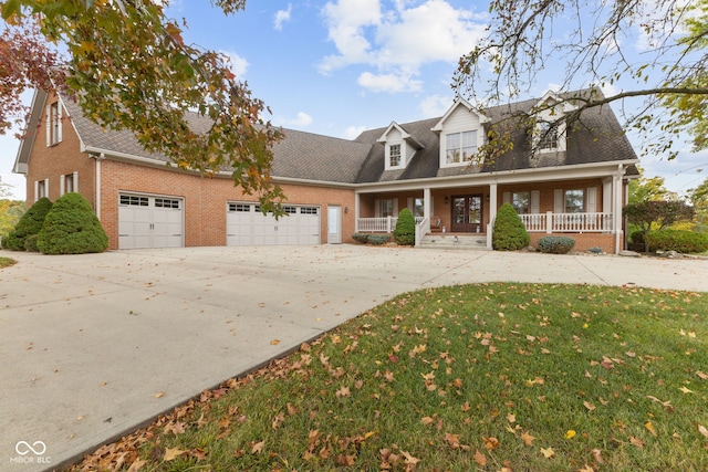 cape cod home with a front lawn, a porch, and a garage