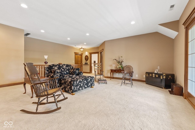 carpeted living room with vaulted ceiling