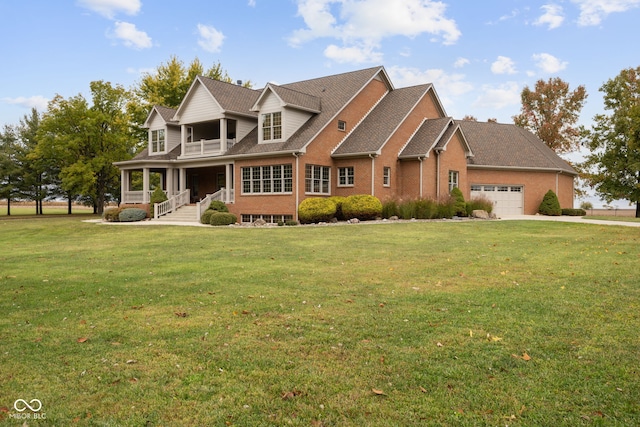 view of front of house featuring a front yard, covered porch, and a garage