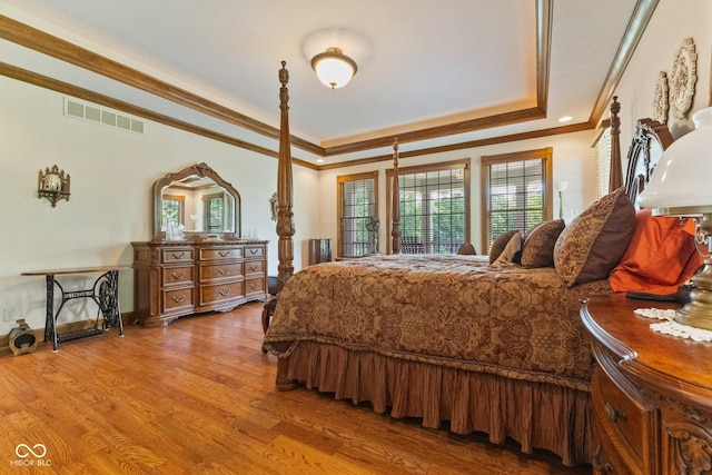 bedroom with crown molding and light hardwood / wood-style floors