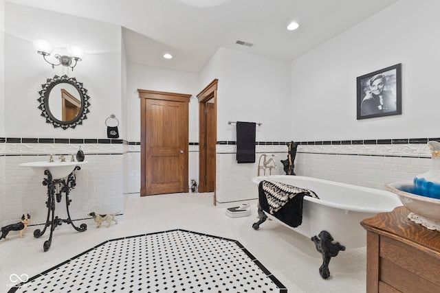 bathroom featuring a tub to relax in and tile walls