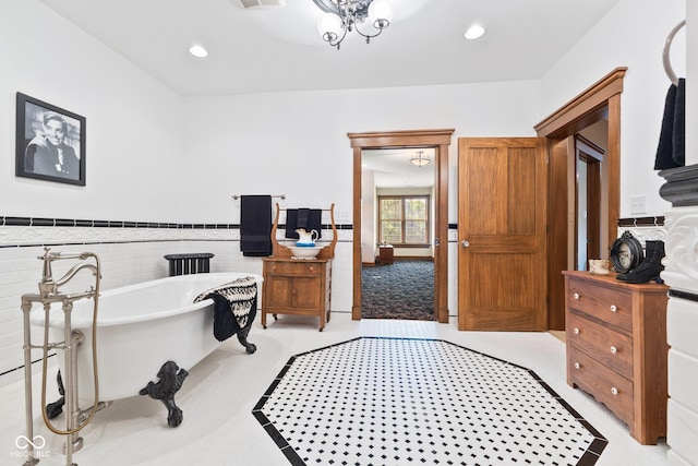 bathroom featuring tile walls and a bathtub