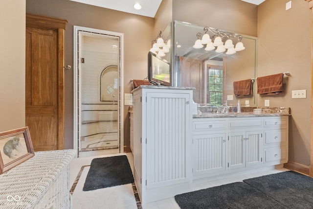 bathroom featuring an enclosed shower, vanity, and tile patterned flooring