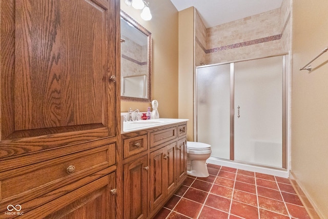 bathroom with vanity, toilet, tile patterned flooring, and walk in shower