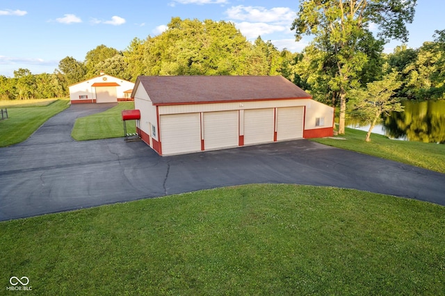 garage with a yard and a water view