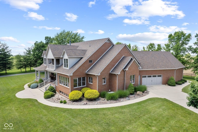 view of front facade featuring a front yard, covered porch, and a garage