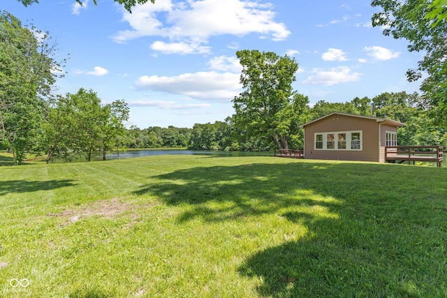 view of yard with a deck with water view