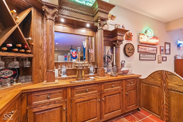 bar featuring butcher block counters and tile patterned flooring