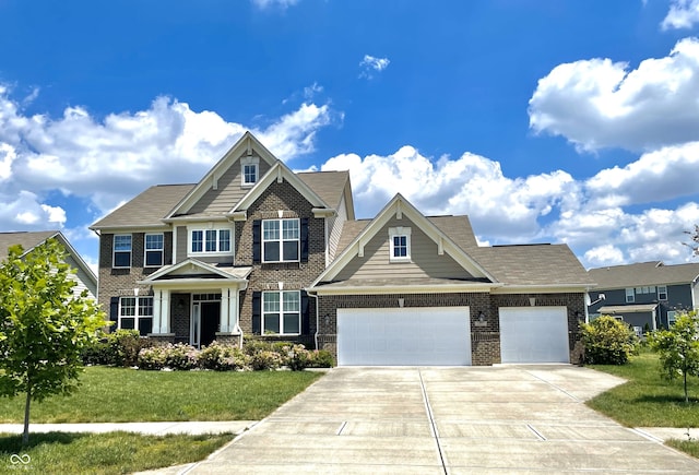 craftsman-style home featuring a garage and a front yard