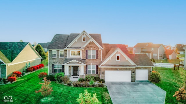 view of front of home with a garage and a front lawn