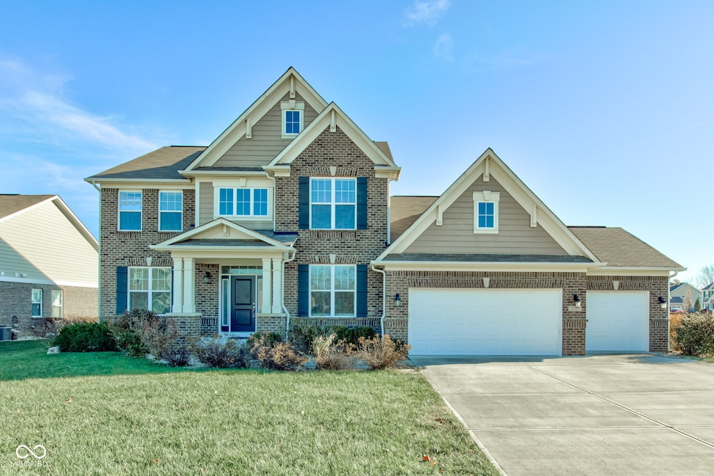 craftsman inspired home featuring a garage, central air condition unit, and a front yard