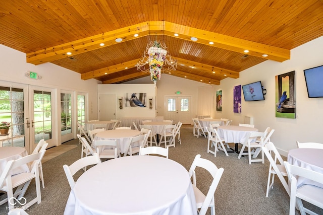 carpeted dining area with vaulted ceiling with beams, wooden ceiling, and french doors