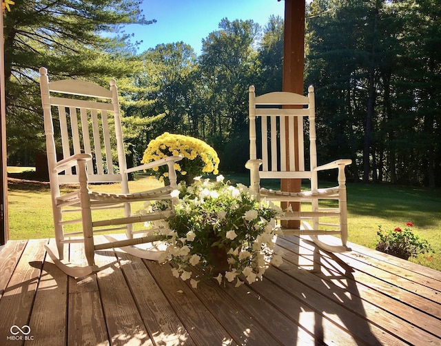 wooden terrace featuring a lawn