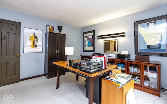 carpeted office with a textured ceiling