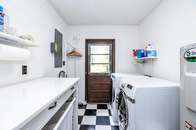 washroom featuring electric panel, washer and dryer, and a textured ceiling