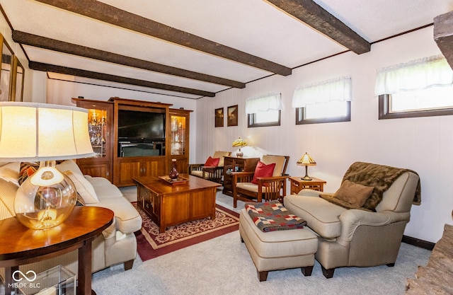 living room with beamed ceiling and light carpet