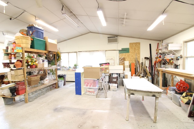 garage featuring a wall mounted air conditioner and a workshop area