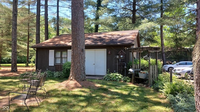 view of outbuilding featuring a lawn