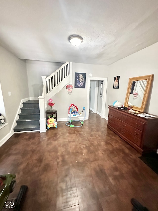 sitting room with a textured ceiling and hardwood / wood-style floors