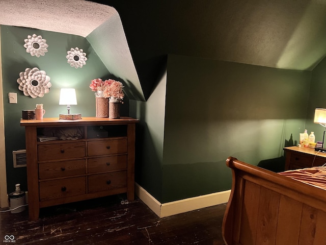 bedroom with dark wood-type flooring and vaulted ceiling