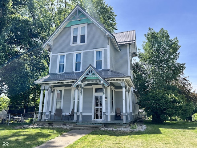 victorian-style house with covered porch and a front yard