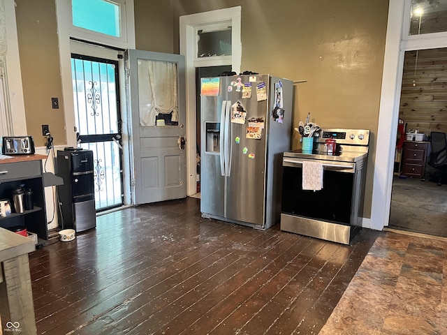 kitchen with stainless steel appliances and dark hardwood / wood-style floors