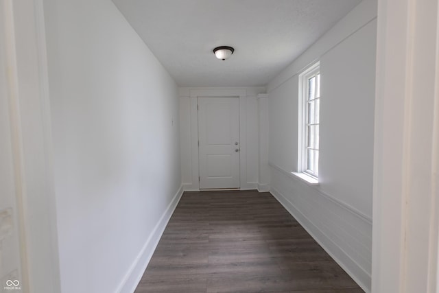 corridor featuring dark hardwood / wood-style floors