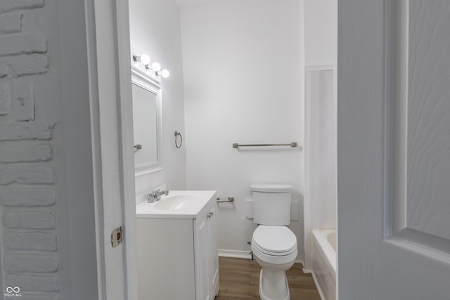 full bathroom featuring wood-type flooring, separate shower and tub, vanity, and toilet