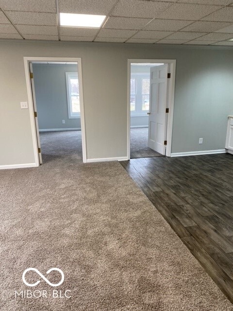2976 N Scatterfield Rd, Anderson, IN 46012 - empty room featuring a paneled ceiling and dark wood-style flooring