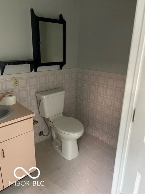 2976 N Scatterfield Rd, Anderson, IN 46012 - half bathroom featuring vanity, tile patterned flooring, and tile walls