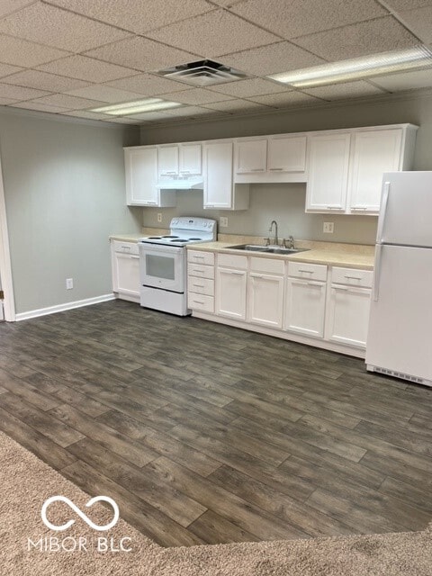 2976 N Scatterfield Rd, Anderson, IN 46012 - kitchen with white appliances, white cabinetry, light countertops, dark wood-style flooring, and under cabinet range hood
