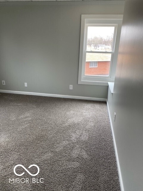 2976 N Scatterfield Rd, Anderson, IN 46012 - spare room featuring carpet floors and baseboards