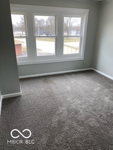 2976 N Scatterfield Rd, Anderson, IN 46012 - carpeted empty room featuring baseboards