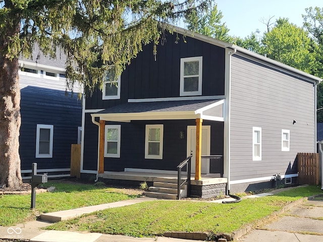 view of front facade featuring covered porch and a front yard