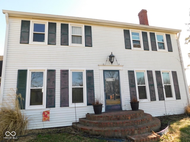 colonial-style house with a chimney