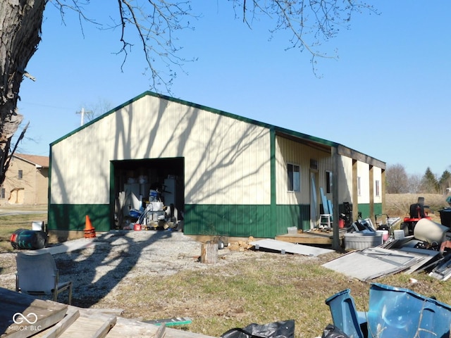 exterior space featuring a detached garage and an outdoor structure