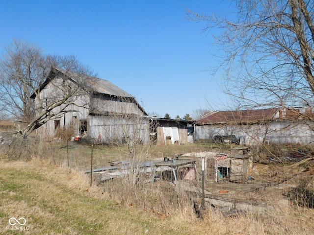 view of yard with a barn and an outbuilding