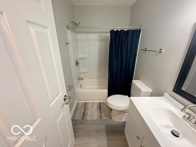 full bathroom with vanity, toilet, a textured ceiling, wood-type flooring, and shower / tub combo